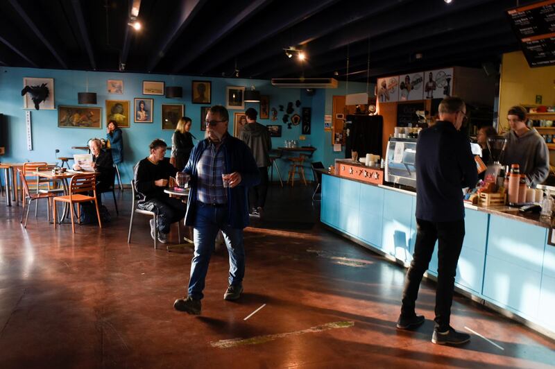 Customers and employees are seen inside a cafe on the first day of all New Zealand domestic regulations being lifted for the coronavirus disease (COVID-19) in Nelson, New Zealand. REUTERS