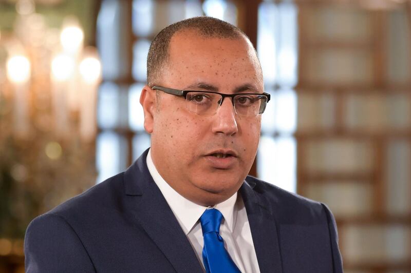 (FILES) In this file photo taken on February 27, 2020 Tunisian Interior Minister Hichem Mechichi takes the oath of office during the country's new government swearing-in ceremony at the Carthage Palace outside the capital Tunis, on February 27, 2020, following a confidence vote by parliament.  Hichem Mechichi, who until now has served as Tunisia's interior minister, has been appointed to form the next government, the president's office said on July 25, 2020. The 46-year-old lawyer succeeds Elyes Fakhfakh, who resigned earlier this month -- but Mechichi was not one of the names proposed by the ruling political parties to President Kais Saied. / AFP / FETHI BELAID
