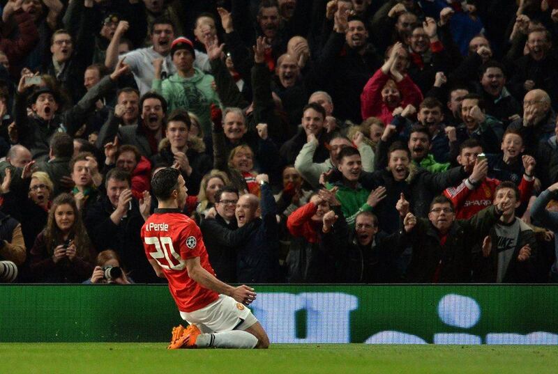 Manchester United's Robin van Persie celebrates scoring his third goal of the game during Wednesday night's victory over Olympiakos at Old Trafford. Paul Ellis / AFP / March 19, 2014