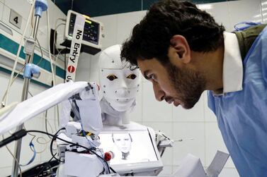 A Cira-03 robot capable of taking swabs for Covid-19 PCR tests. The IMF says the main priority for Mena countries is ensuring healthcare systems are adequately resourced, while investing in green infrastructure and digitalisation will accelerate the economic recovery from the pandemic. Getty Images