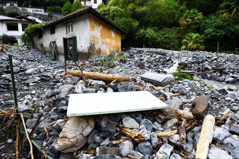 Houses near Lake Como, Italy, were hit by a landslide on Tuesday after heavy rain caused flooding.