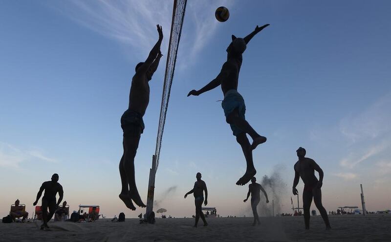 Brazilians play beach volleyball on Copacabana beach, near the Rio 2016 Olympic Games beach volleyball stadium. Mario Tama / Getty Images