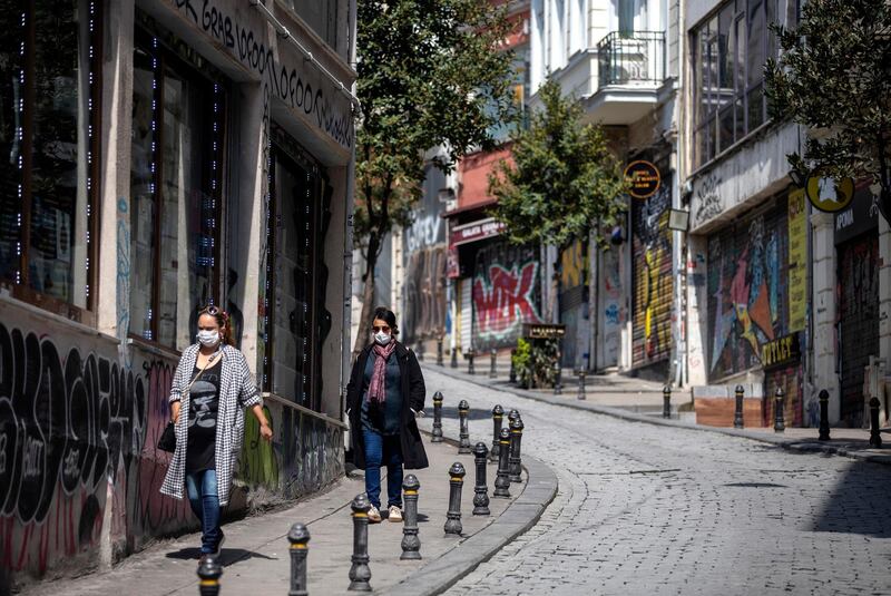 epa08331841 People with face mask walk on the street as the city is almost deserted over coronavirus concerns in Istanbul, Turkey, 30 March 2020. Turkish Health Minister Koca said on 29 March that there are 9,217 confirmed novel coronavirus cases with 131 related deaths to the infectious disease. Turkey on 27 March suspended all international flights, and all inter-city travels are subject to local authorities' permission as part of measures to prevent to spread of the coronavirus. The country decided also to halt public events, to temporarily shut down schools and suspend sporting events.  EPA/ERDEM SAHIN