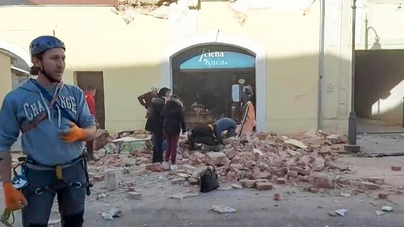 A grab of a video taken and released by the Croatian Red Cross on shows people looking through the rubbles and rescuing victims in the streets of Petrinja, after the town was striked by an earthquake of 6,4 magnitude.  AFP