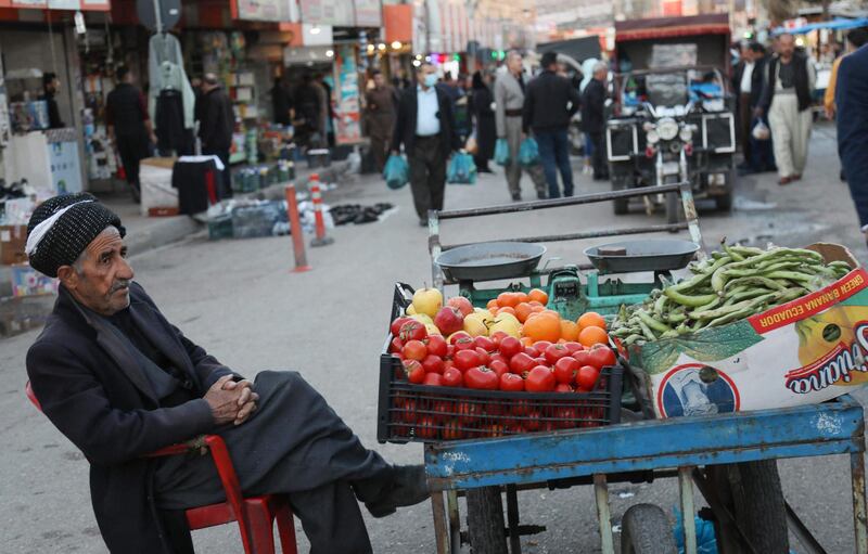 A Kurdish vendor sits next to his produce in the Kurdish town oof Halabja, 300 kms (190 miles) northeast of Baghdad. AFP