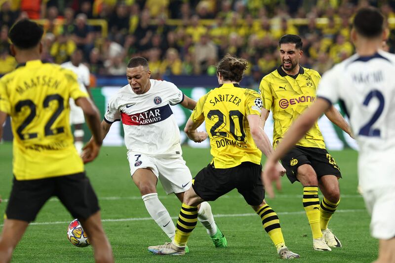 Kylian Mbappe attempts to skip a challenge from Dortmund midfielder Marcel Sabitzer. AFP