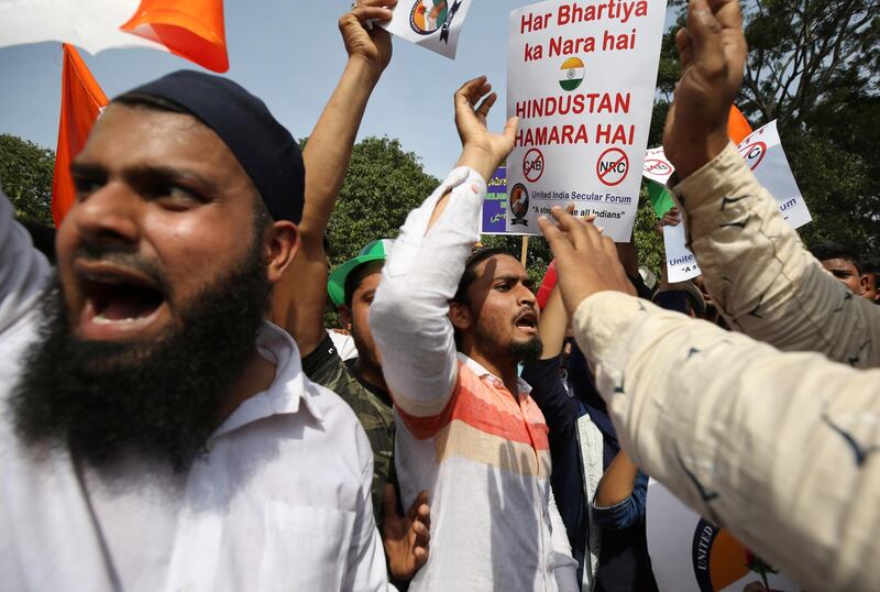 Indians hold placards and shout slogans during a protest organized by several Muslim organizations against a new citizenship law that opponents say threatens India's secular identity in Bangalore, India, Monday, Dec. 23, 2019. More than twenty people have been killed nationwide since the law was passed in Parliament earlier this month in protests that represent the first major roadblock for Prime Minister Narendra Modi's Hindu nationalist agenda since his party's landslide re-election last spring. (AP Photo/Aijaz Rahi)