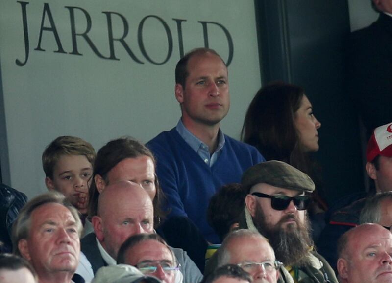 Britain's Prince William and Prince George in the stands during the match. Reuters