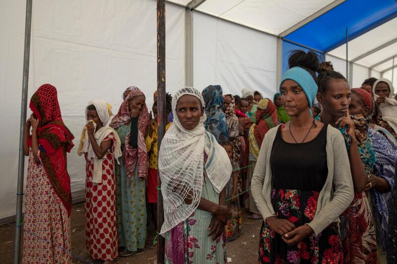 Tigray women who fled the conflict in the Ethiopia's Tigray region, stand in line to register their names at Hamdayet Transition Center, eastern Sudan. AP Photo