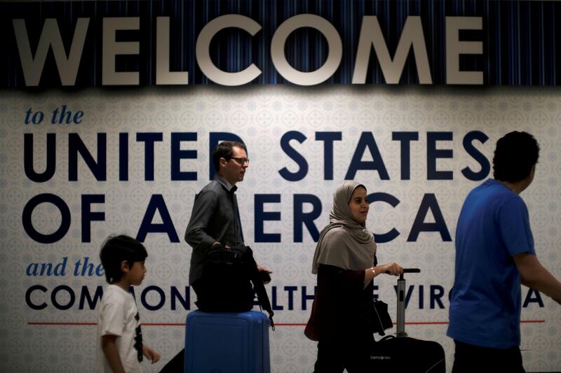 FILE PHOTO: International passengers arrive at Washington Dulles International Airport after the U.S. Supreme Court granted parts of the Trump administration's emergency request to put its travel ban into effect later in the week pending further judicial review, in Dulles, Virginia, U.S., June 26, 2017. REUTERS/James Lawler Duggan/Files