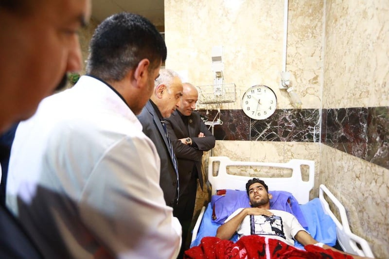 A handout image released by the press office of Iraqi Prime Minister Adel Abdel Mahdi on September 10, 2019 shows him visiting an injured person at the hospital in Baghdad, Iraq, on September 10, 2019. More than 30 pilgrims were killed and dozens injured on September 10 ,2019 in a stampede at a major shrine in the Iraqi city of Karbala on the Shiite holy day of Ashura. - RESTRICTED TO EDITORIAL USE - MANDATORY CREDIT "AFP PHOTO / IRAQI PRIME MINISTER'S PRESS OFFICE" - NO MARKETING - NO ADVERTISING CAMPAIGNS - DISTRIBUTED AS A SERVICE TO CLIENTS
 / AFP / IRAQI PRIME MINISTER'S PRESS OFFICE / - / RESTRICTED TO EDITORIAL USE - MANDATORY CREDIT "AFP PHOTO / IRAQI PRIME MINISTER'S PRESS OFFICE" - NO MARKETING - NO ADVERTISING CAMPAIGNS - DISTRIBUTED AS A SERVICE TO CLIENTS
