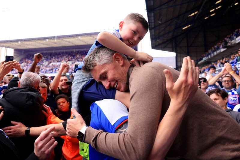 Ipswich manager Kieran McKenna celebrates with a young fan and his dad. Getty Images