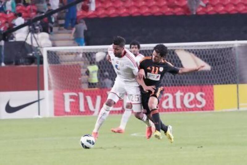 Khamis Ismail, left, tries keeping Ahmed Ibrahim Ateef of the Saudi Arabian side Al Shabab off the ball in their Asian Champions League match.
