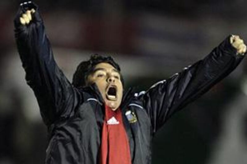 Diego Maradona celebrates Mario Bolatti's World Cup finals-clinching goal against Uruguay on Wednesday night.