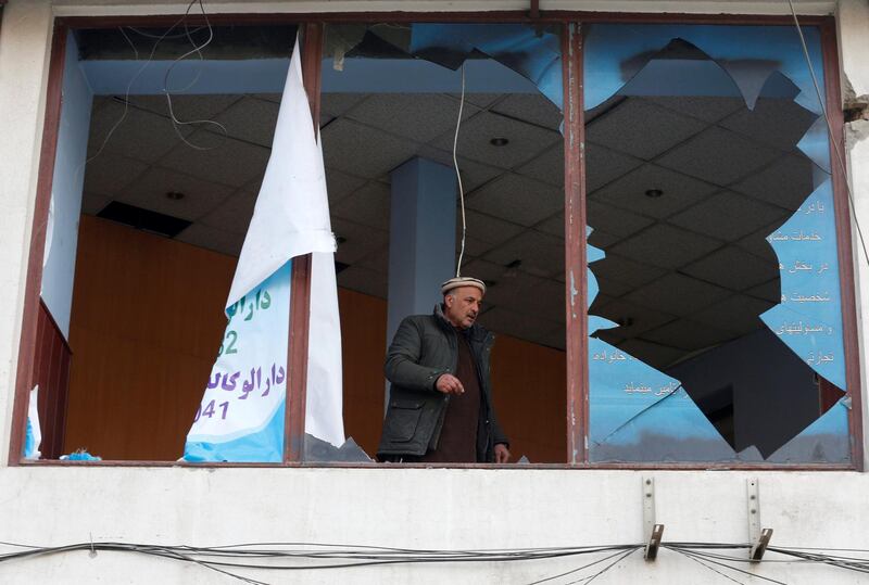 An Afghan shopkeeper removes the broken glass window of his shop near the site of a bomb attack in Kabul, Afghanistan, January 28, 2018. REUTERS/Omar Sobhani