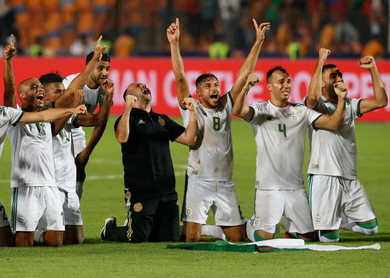 Algeria's manager Djamel Belmadi, centre, celebrates with his players at the final whistle. AP