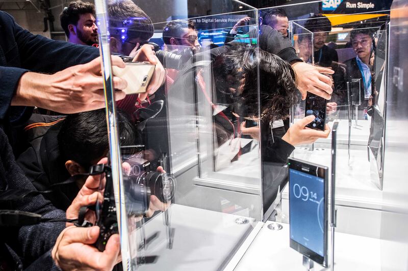 Visitors take photos of the new Sony Xperia XZ on display during the Mobile World Congress 2017. David Ramos / Getty Images