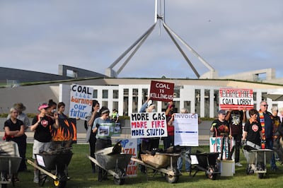 epa08210345 Bushfire survivors use burnt debris from the recent bushfires to create a symbolic 'trail of destruction' outside Parliament House in Canberra, Australian Capital Territory, Australia, 11 February 2020. Bushfire survivors converge in Canberra to shine a light on the coal lobby's 'trail of destruction', and call for an end to the influence of the Minerals Council of Australia and the coal lobby over politicians.  EPA/MICK TSIKAS  AUSTRALIA AND NEW ZEALAND OUT