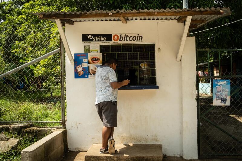 A person purchases a bottle of Coca-Cola from a shop that accepts Bitcoin in El Zonte, El Salvador, on Monday, June 14, 2021. El Salvador has become the first country to formally adopt Bitcoin as legal tender after President Nayib Bukele said congress approved his landmark proposal. Photographer: Cristina Baussan/Bloomberg