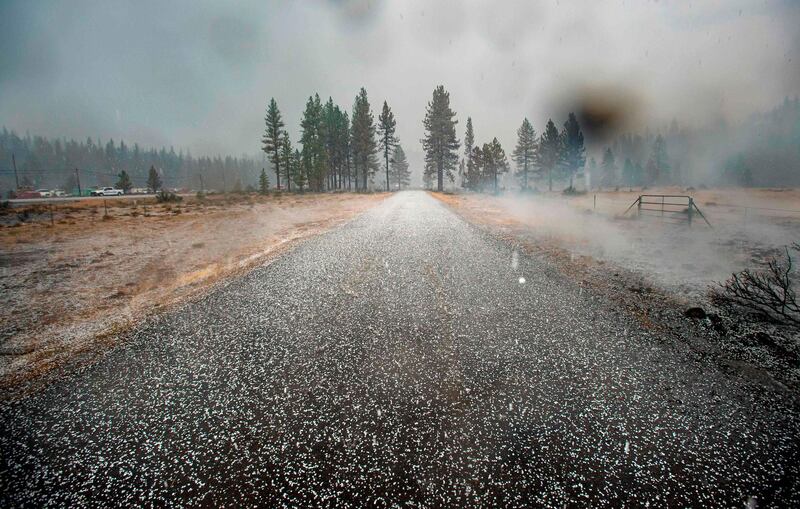 Hail covers a road in at a still smoldering area of the Hog fire near Susanville, California, US. AFP