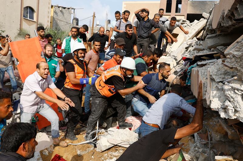 Palestinians search for casualties in a house destroyed by Israeli strikes in Khan Younis, in the southern Gaza Strip. Reuters