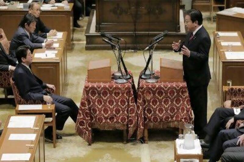 Japanese prime minister Yoshiko Noda, right, debates with Japan's main opposition Liberal Democratic Party president Shinzo Abe in Parliament on Wednesday.