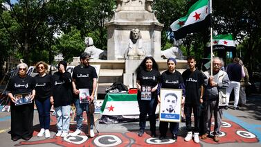 Syrian activists outside the court in Paris on Tuesday. EPA