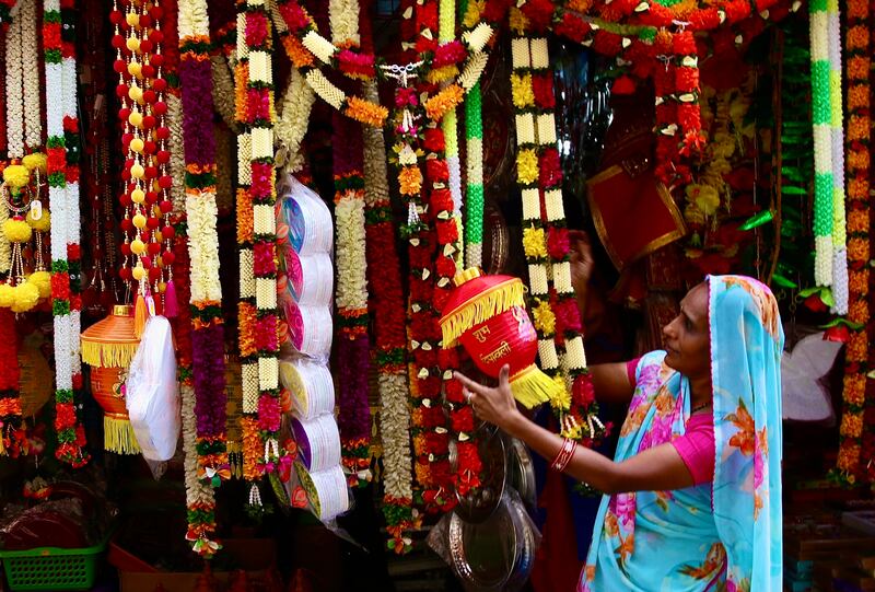A woman looks at decorative items and crackers offered at a market stand ahead of Diwali in Bangalore. EPA