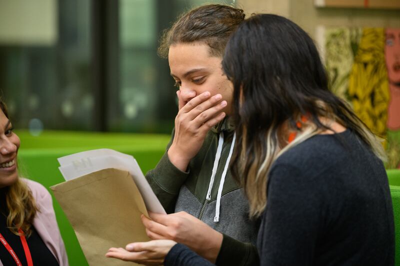 Souhaib Boettgenbach, centre, sees his GCSE results at Westminster Academy in London. Getty Images