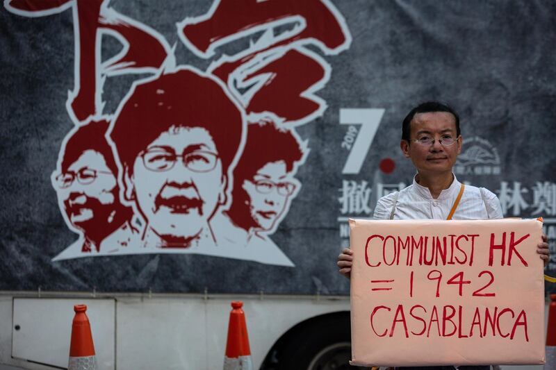 A protester holds a sign reading "Communist HK = 1942 Casablanca" during the annual pro-democracy rally. Bloomberg