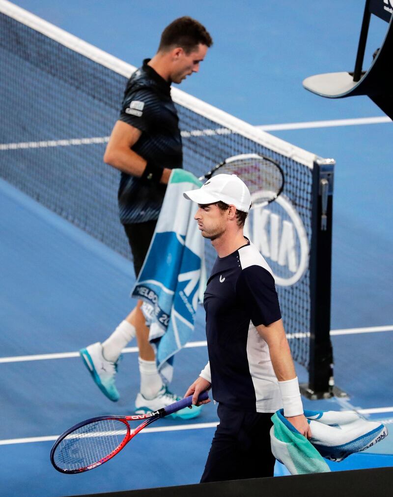 Andy Murray (front) of Britain walks past Roberto Bautista Agut (back) of Spain during their men's singles first round match at the Australian Open Grand Slam tennis tournament in Melbourne, Australia.  EPA
