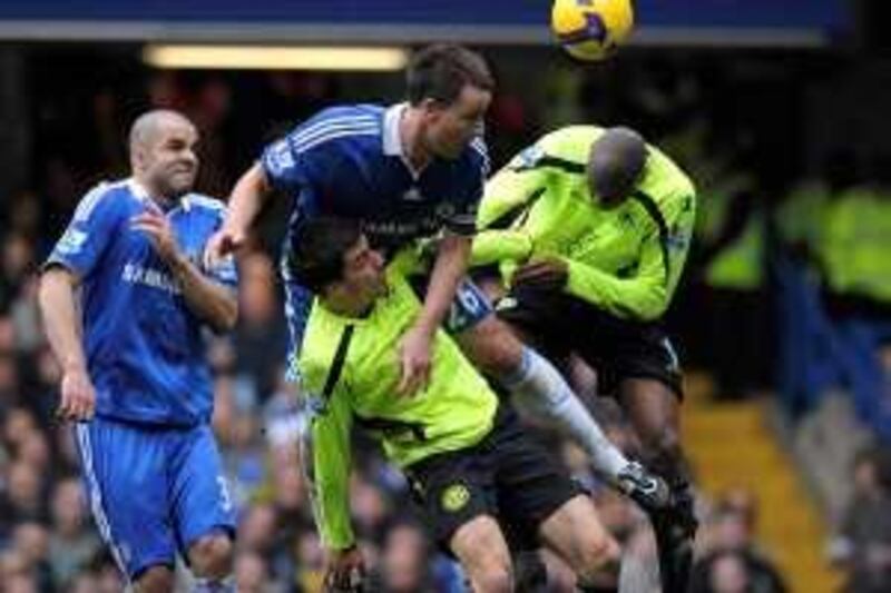 Chelsea's John Terry (C) heads the ball during their English Premier League soccer match against Wigan Athletic at Stamford Bridge in London February 28, 2009.    REUTERS/Kieran Doherty   (BRITAIN).  NO ONLINE/INTERNET USAGE WITHOUT A LICENCE FROM THE FOOTBALL DATA CO LTD. FOR LICENCE ENQUIRIES PLEASE TELEPHONE ++44 (0) 207 864 9000.
Picture Supplied by Action Images *** Local Caption *** 2009-02-28T160558Z_01_KFD06_RTRIDSP_3_SOCCER-ENGLAND.jpg
