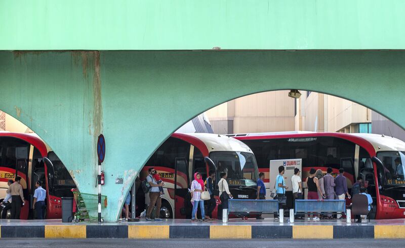 Residents wait for buses under the distinctive arches of the Abu Dhabi main bus terminal. Victor Besa / The National