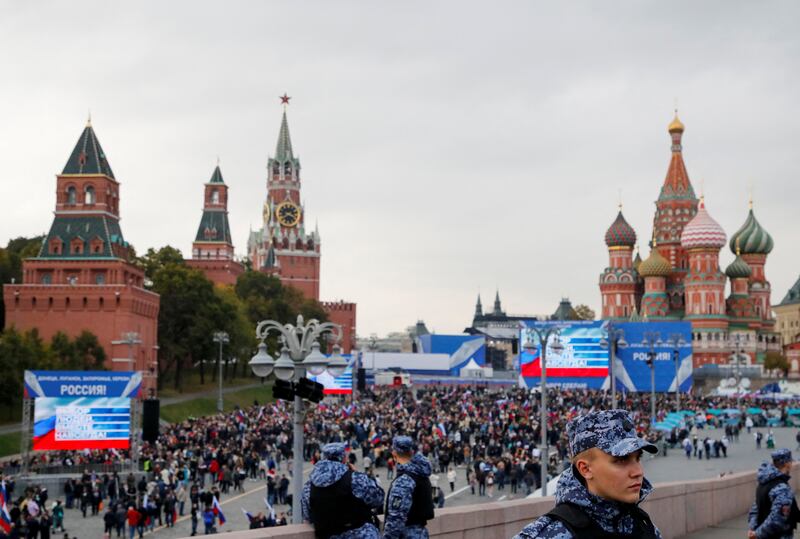 Law enforcement officers stand guard as people walk towards Red Square to attend the ceremony marking the annexation of the Russian-controlled territories. Reuters