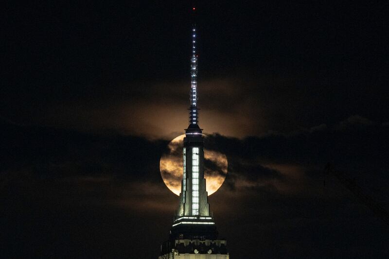 The supermoon, also known as the 'buck moon', rises over the New York City skyline. Reuters