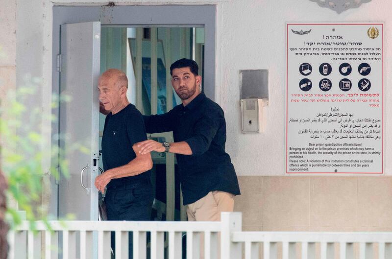 Former Israeli prime minister Ehud Olmert, left, 71, leaves the Maasyahu prison on July 2, 2017 in Ramla, who was freed from prison after being granted parole in a corruption case that reduced his sentence by a third. Jack Guez/AFP Photo