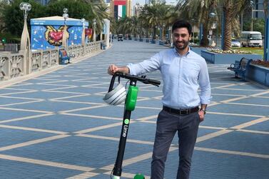 Lime's UAE general manager Mohamad Nsouli tries out one of the scooters on the Corniche. Courtesy: Lime / Grayling PR