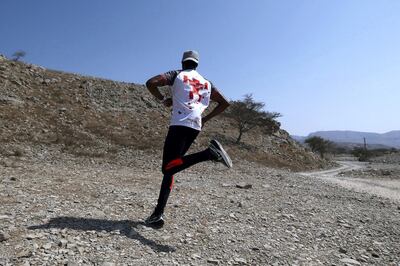 RAK, UNITED ARAB EMIRATES , Feb 23 –  Frank Golya from Kenya running in the mountains near his home in Ras Al Khaimah. (Pawan Singh / The National) For News/Online/Instagram/Big Picture. Story by Haneen