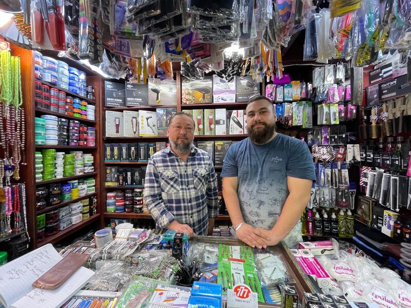 Khaled Bukhari and his son Muhiyideen at the father’s grooming products shop in Bukhari market. 