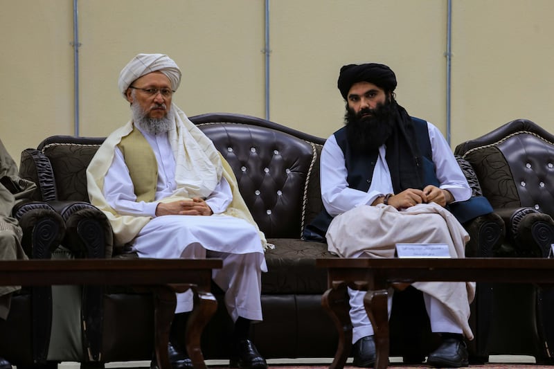 Taliban Second Deputy Prime Minister Abdul Salam Hanafi, left, and Interior Minister Sirajuddin Haqqani attend a ceremony to announce the ban on poppy cultivation. EPA