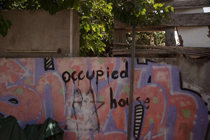 Graffitti marks the outer wall of the al-Kurd family property in the Sheikh Jarrah neighborhood of east Jerusalem, one of several Palestinian families under threat of forced eviction, Tuesday, May 11, 2021. Part of their property is already occupied by Jewish settlers. (AP Photo/Maya Alleruzzo)