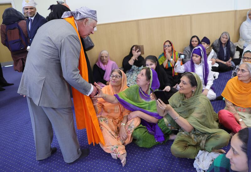 King Charles speaks to congregation members at Guru Nanak Gurdwara. PA