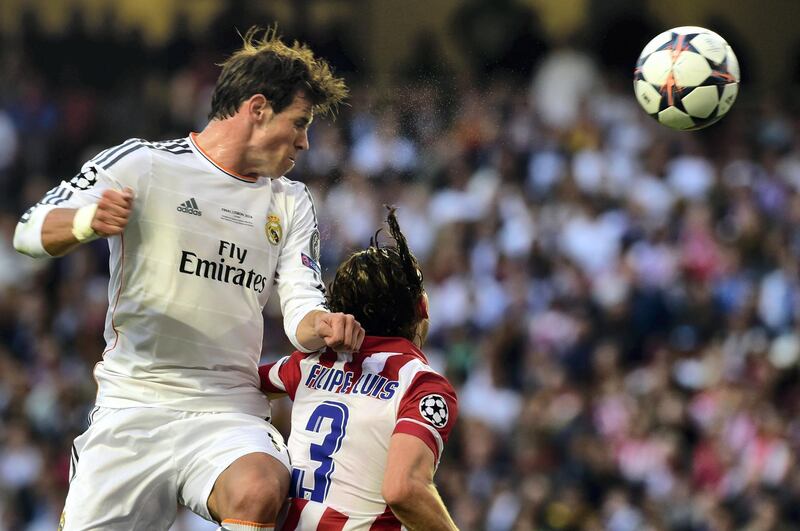 Real Madrid's Welsh forward Gareth Bale heads the ball during the UEFA Champions League Final Real Madrid vs Atletico de Madrid at Luz stadium in Lisbon, on May 24, 2014.   AFP PHOTO/ GERARD JULIEN (Photo by GERARD JULIEN / AFP)