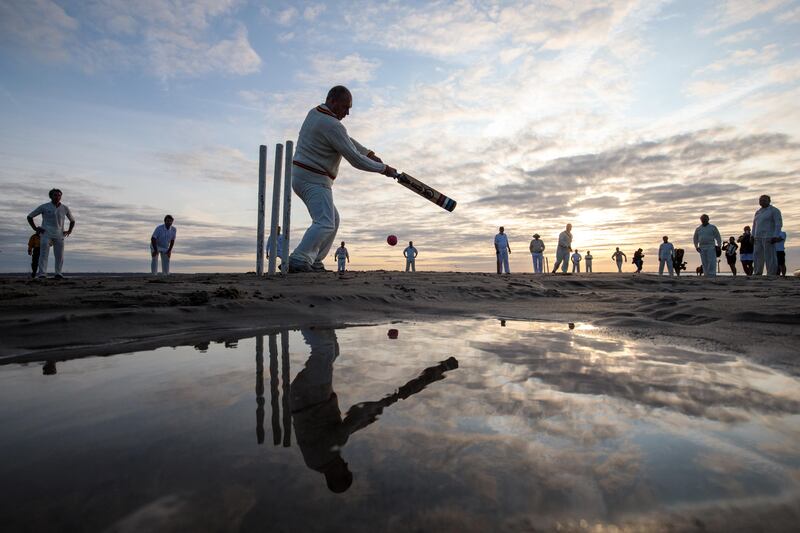 Teams play a cricket match on the Brambles sandbank at low tide  in Hamble, southern England. Jack Taylor / Getty Images