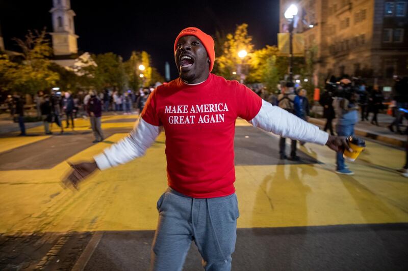 A supporter of US President Donald Trump taunts Biden Supporters in Black Lives Matter Plaza near the White House in Washington, DC.  EPA