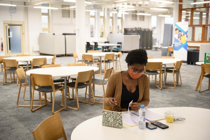 Agnes Cheba Ade, an International Economics student at Coventry University. Poring over her books in the library, far from her home in Equatorial Guinea, she is determined to keep up her studies despite coronavirus restrictions. AFP