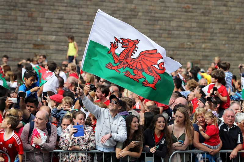 Fans in Cardiff wait to welcome home the Wales team after their exit from the Euro 2016 championships. 