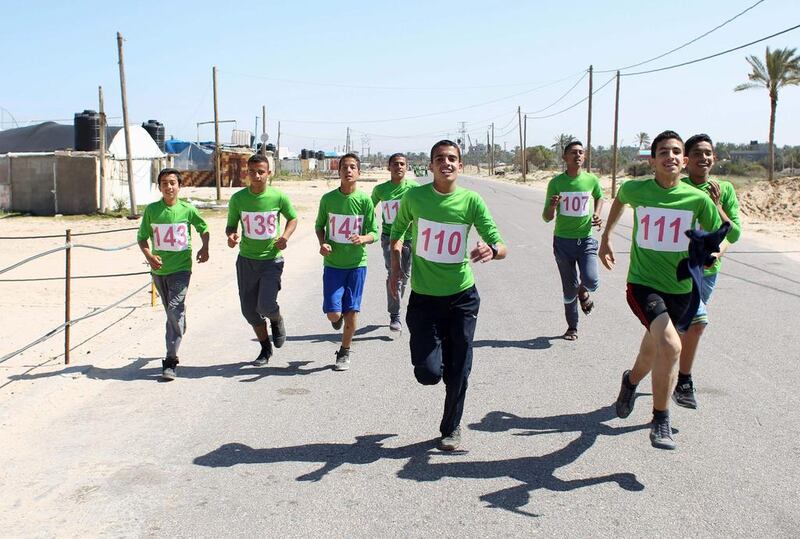 Palestinian youths take part in a local-run marathon in Khan Yonis in the southern Gaza Strip. Said Khataib / AFP