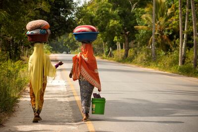 Women on a road in Zanzibar. (Photo by:  BSIP/UIG via Getty Images)