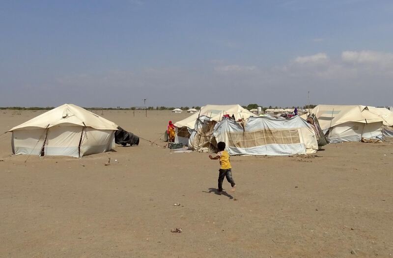 A child runs toward a tent in the Khokha district, Hodeidah, Yemen. AFP